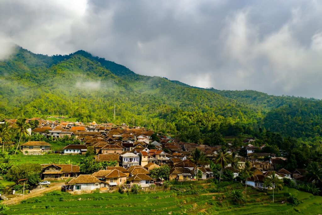 Picturesque village surrounded by lush green hills in Majasari, Indonesia.